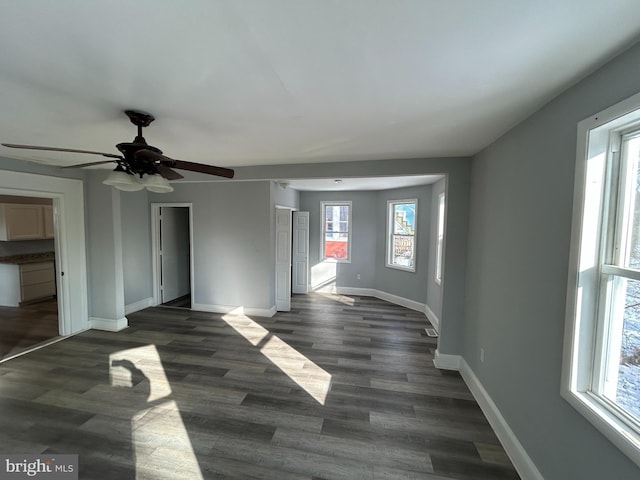 unfurnished living room with dark wood-type flooring