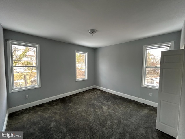 carpeted empty room featuring plenty of natural light