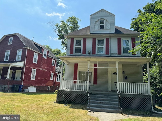 view of front facade with covered porch and a front yard