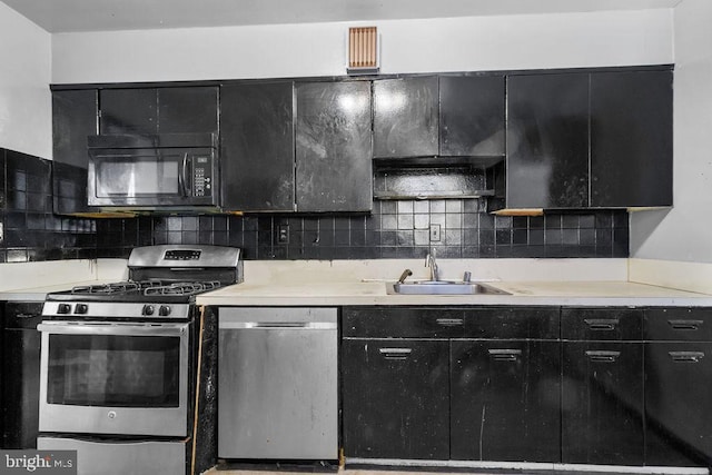 kitchen with sink, decorative backsplash, and appliances with stainless steel finishes