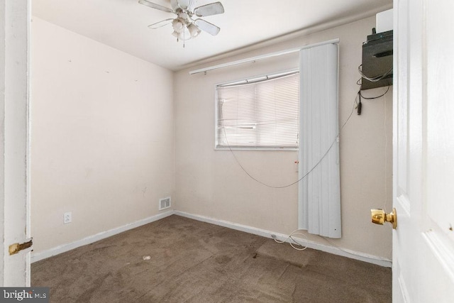 empty room featuring ceiling fan and carpet