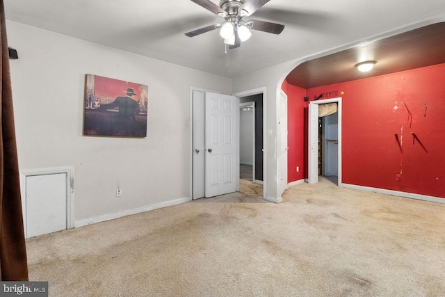 unfurnished bedroom featuring light carpet and ceiling fan