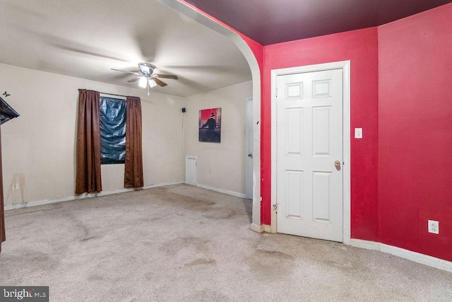 entrance foyer with ceiling fan and light carpet