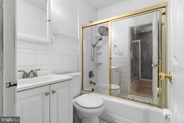 full bathroom featuring tile walls, combined bath / shower with glass door, vanity, and toilet