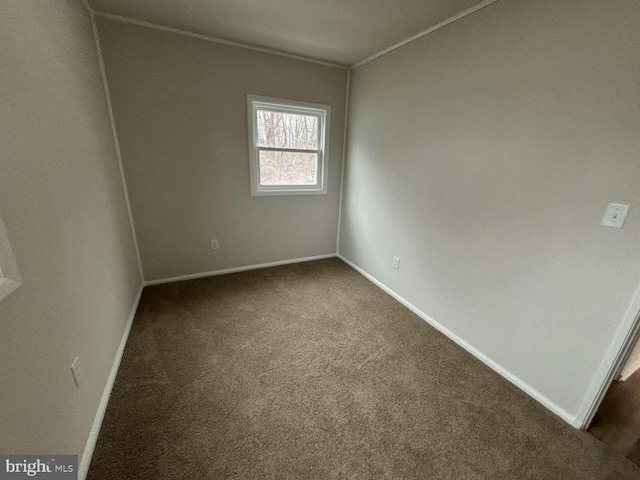 empty room featuring dark colored carpet