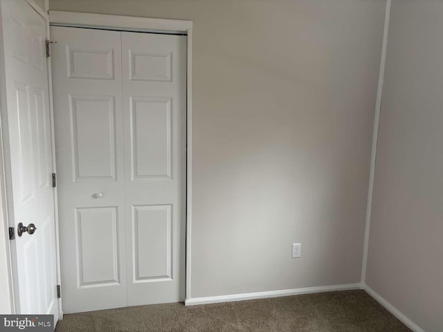 unfurnished bedroom featuring a closet and carpet