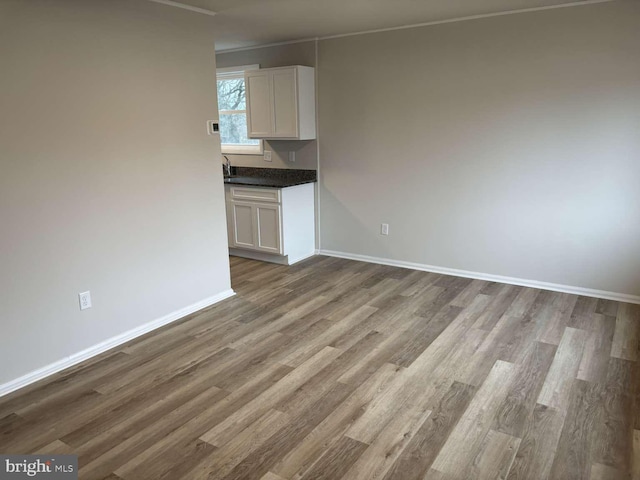 unfurnished living room featuring wood-type flooring