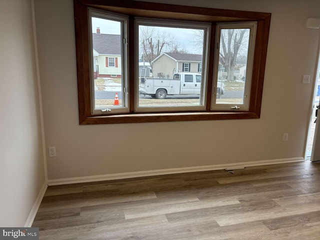 unfurnished room featuring hardwood / wood-style flooring and plenty of natural light