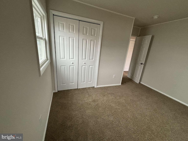 unfurnished bedroom with carpet floors and a closet