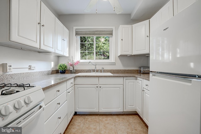 kitchen featuring sink, white appliances, and white cabinetry