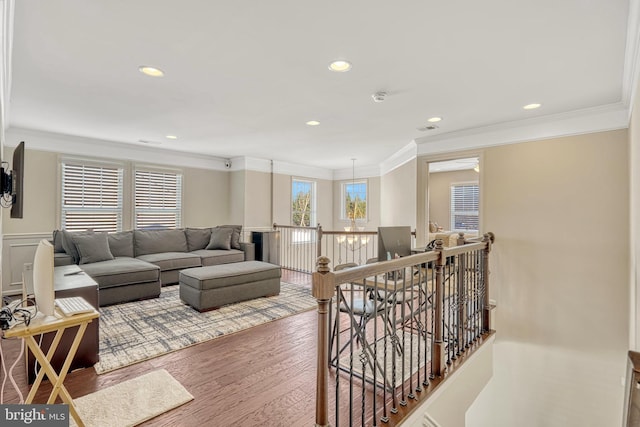 living room with crown molding and hardwood / wood-style flooring