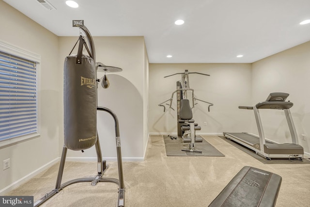 exercise room featuring light carpet