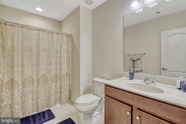 bathroom featuring tile patterned flooring, vanity, and toilet