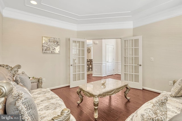 living room featuring french doors, wood-type flooring, and crown molding