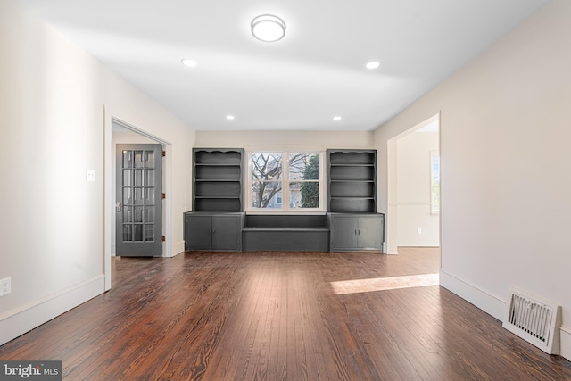 unfurnished living room featuring dark hardwood / wood-style floors