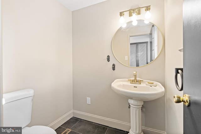 bathroom featuring toilet and tile patterned floors