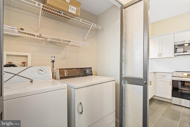 laundry area with light tile patterned flooring and separate washer and dryer