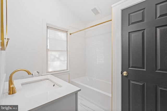 bathroom with shower / bath combination, vaulted ceiling, and vanity