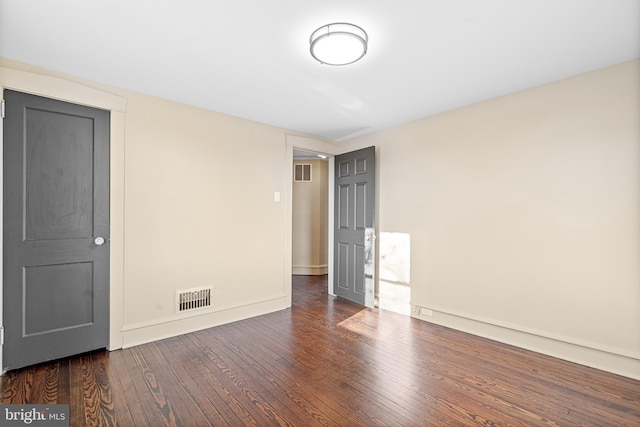 spare room featuring dark hardwood / wood-style flooring