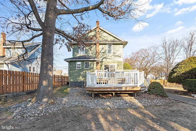 rear view of property featuring a deck