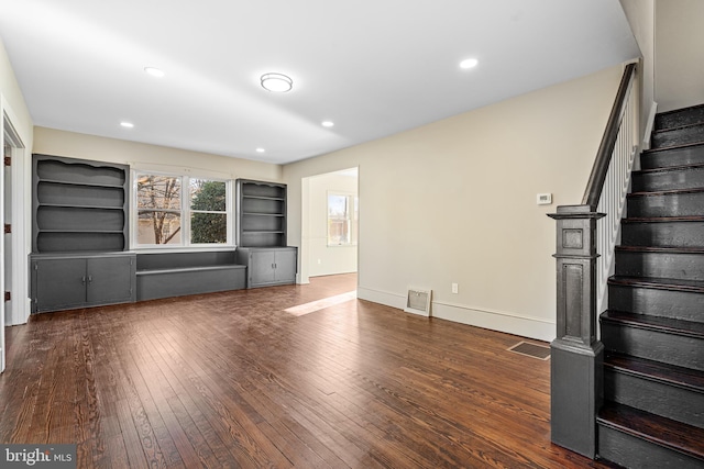 unfurnished living room with dark hardwood / wood-style floors