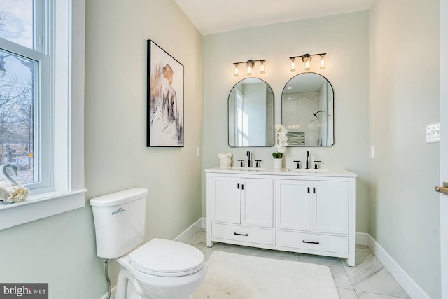 bathroom featuring vanity, a shower, and toilet