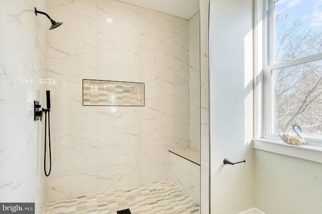 bathroom featuring a tile shower