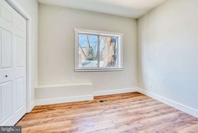 spare room with light hardwood / wood-style flooring