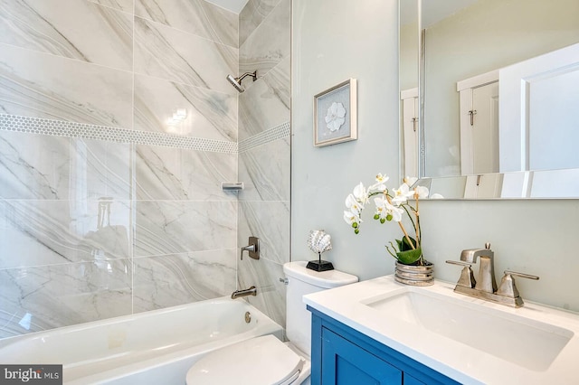 full bathroom with tiled shower / bath combo, vanity, and toilet