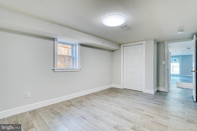 basement with light hardwood / wood-style flooring