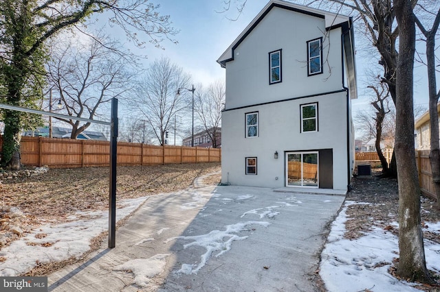 snow covered property featuring cooling unit