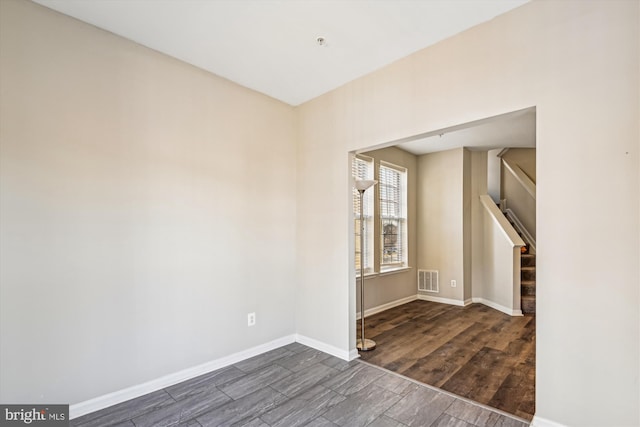 unfurnished room with dark hardwood / wood-style floors