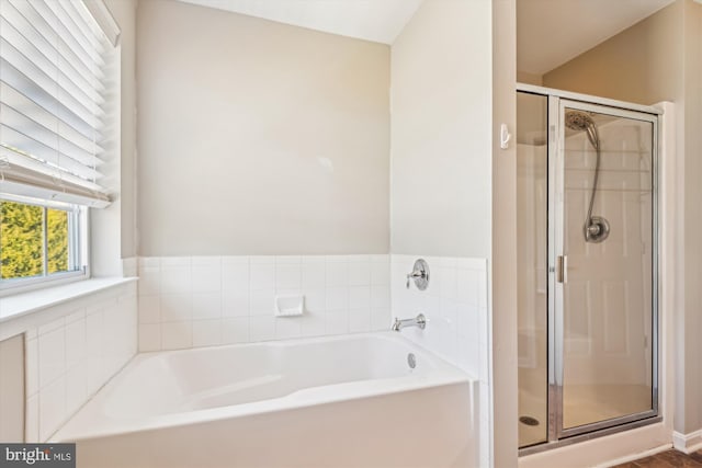 bathroom featuring independent shower and bath