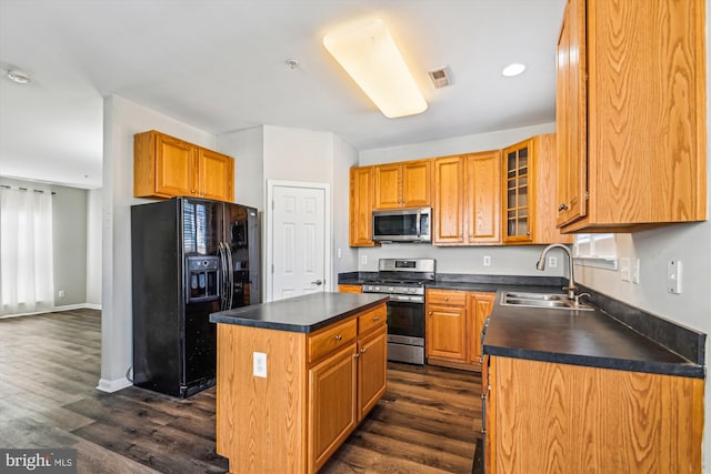 kitchen featuring sink, stainless steel appliances, dark hardwood / wood-style floors, and a kitchen island