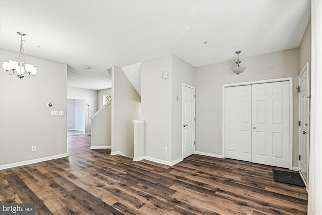 foyer entrance with a chandelier and dark hardwood / wood-style flooring