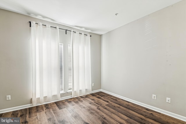 empty room featuring dark wood-type flooring