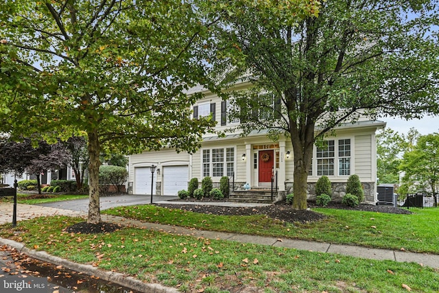 view of front facade featuring a garage and a front lawn