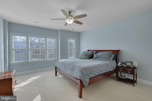 bedroom featuring light carpet and ceiling fan