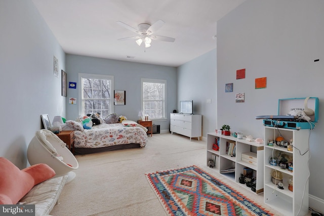 bedroom featuring light carpet and ceiling fan