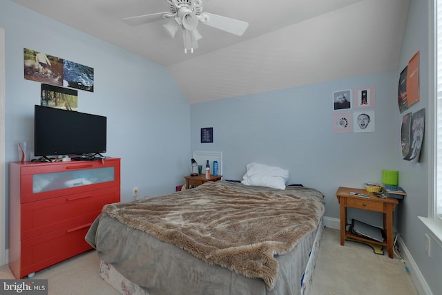 carpeted bedroom with vaulted ceiling and ceiling fan