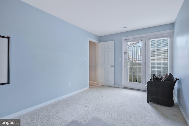 unfurnished room with light colored carpet