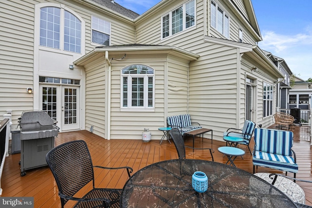 wooden deck featuring area for grilling and french doors