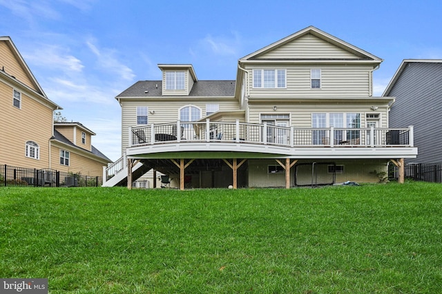 rear view of property featuring a wooden deck and a yard