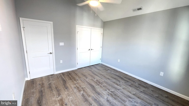 unfurnished bedroom featuring wood-type flooring, high vaulted ceiling, and ceiling fan