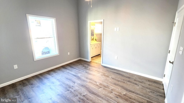 unfurnished room featuring wood-type flooring and a wealth of natural light