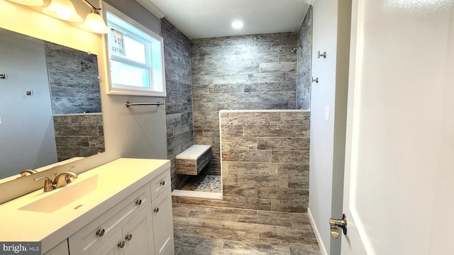 bathroom featuring vanity and tiled shower