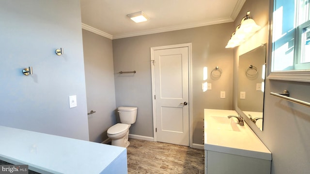 bathroom featuring crown molding, vanity, and toilet