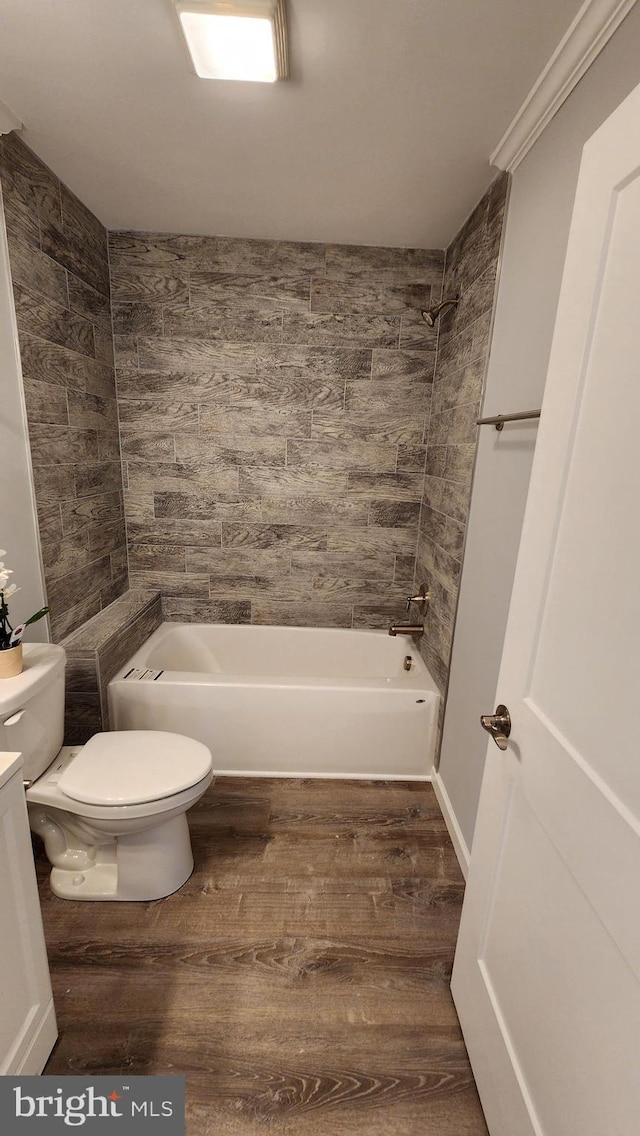 full bathroom with wood-type flooring, ornamental molding, vanity, toilet, and tub / shower combination