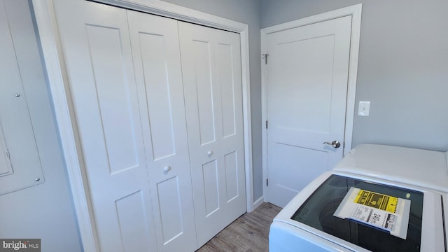 laundry area with washer / clothes dryer and light wood-type flooring