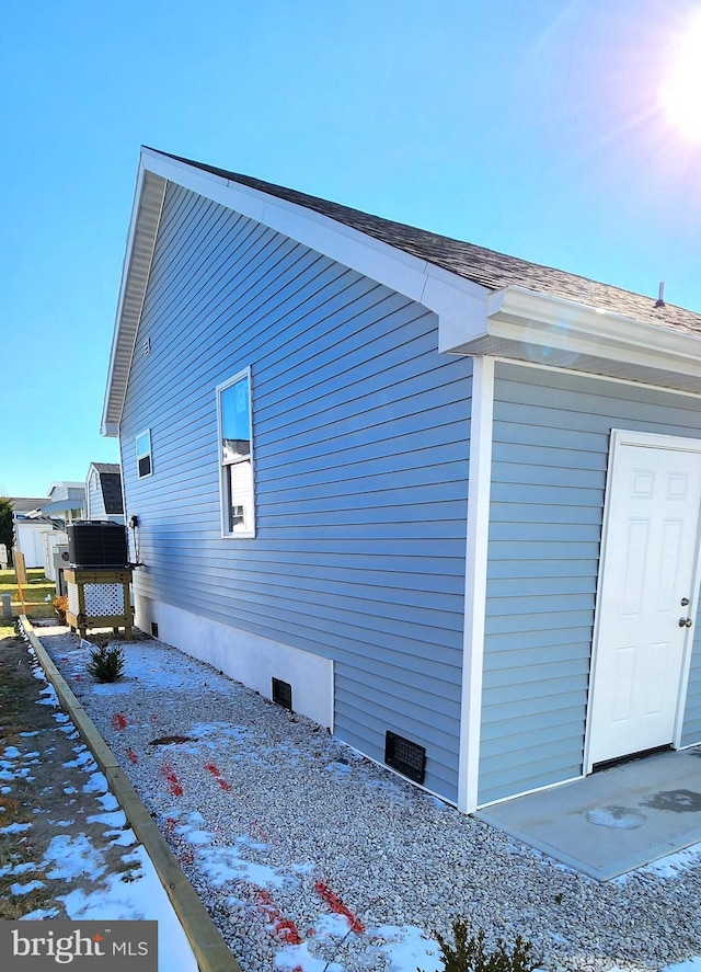 view of side of home featuring central air condition unit